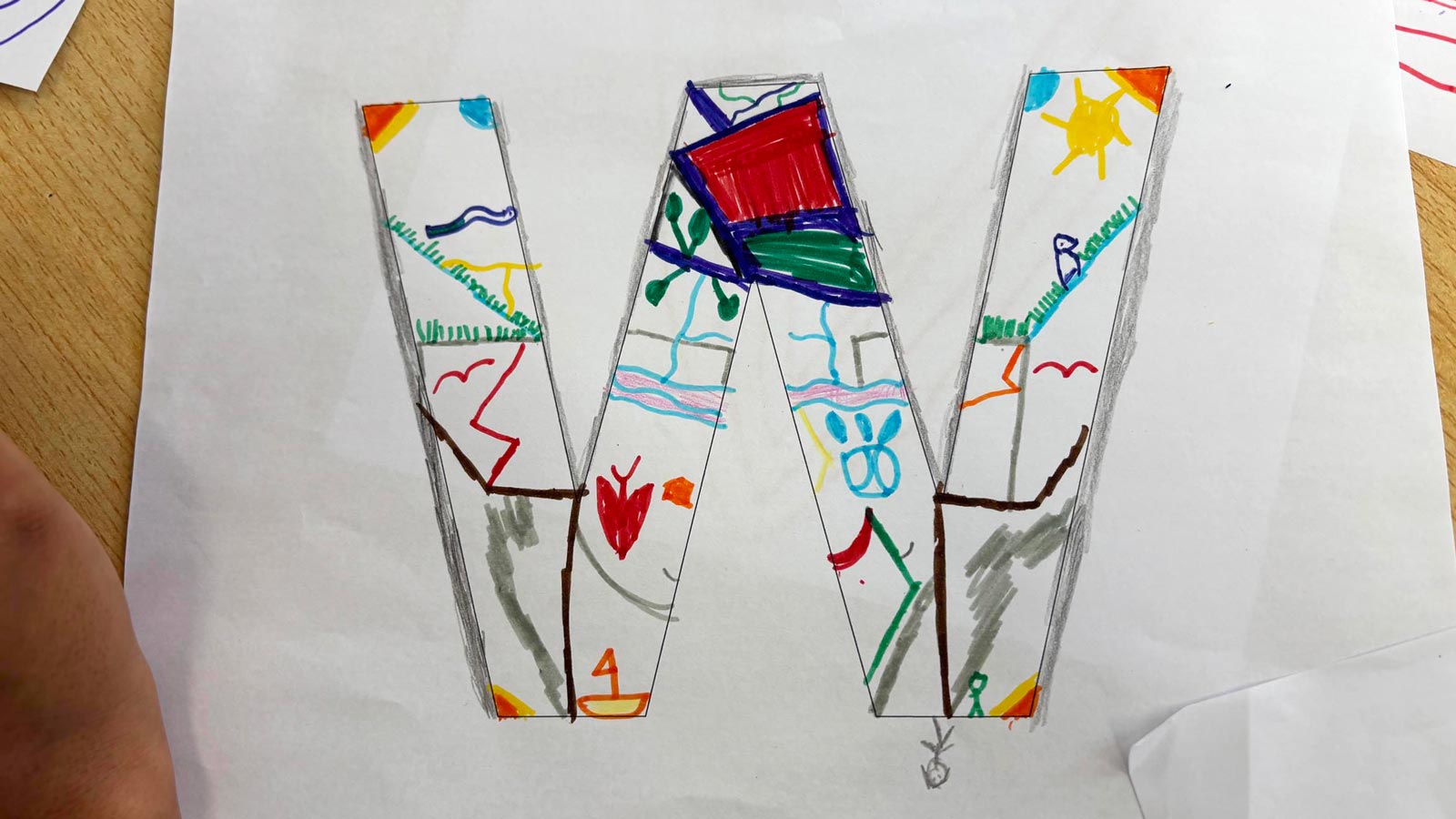 A child's drawing of a W from Together We.