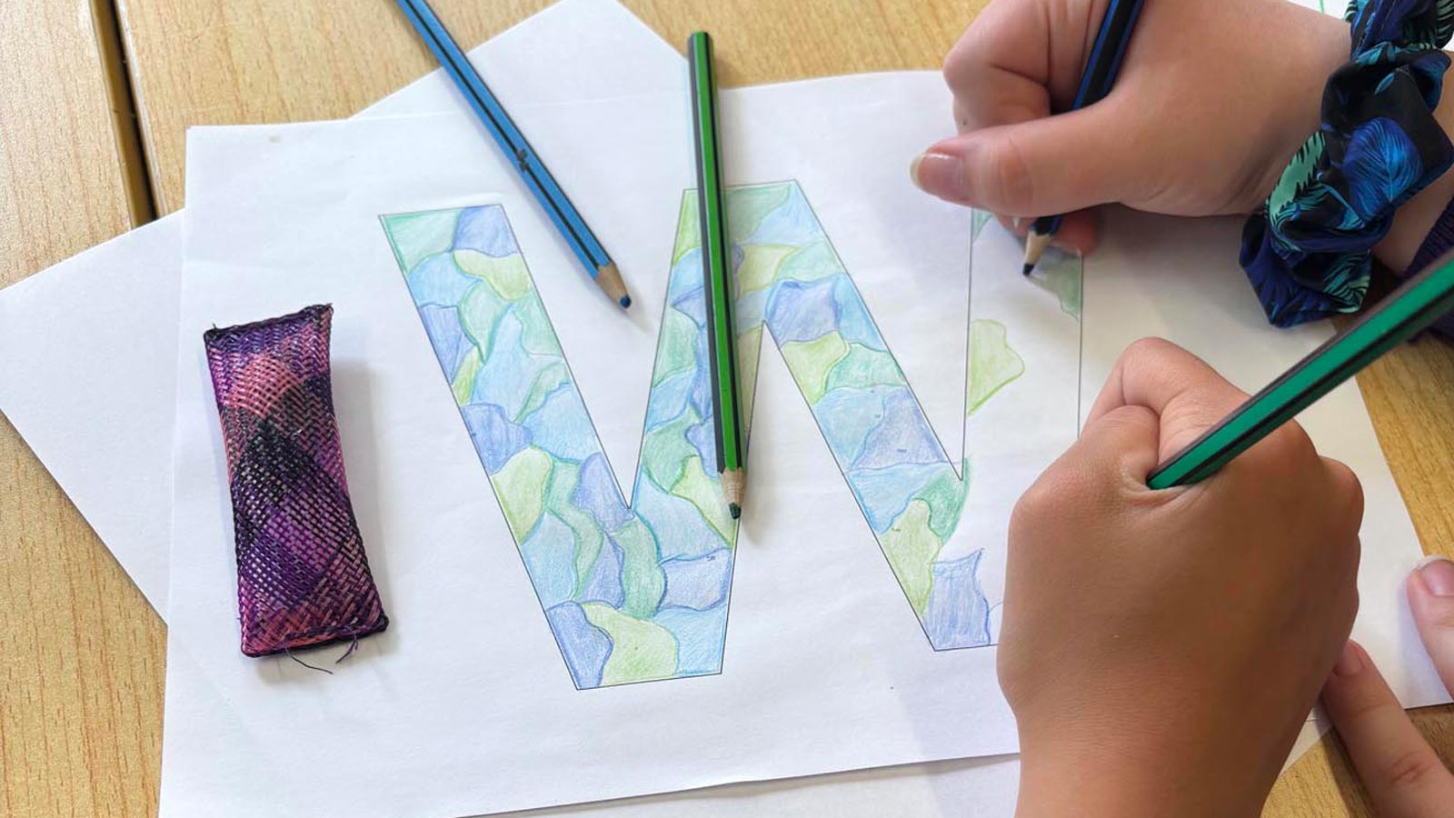 A child's drawing of a W from Together We.